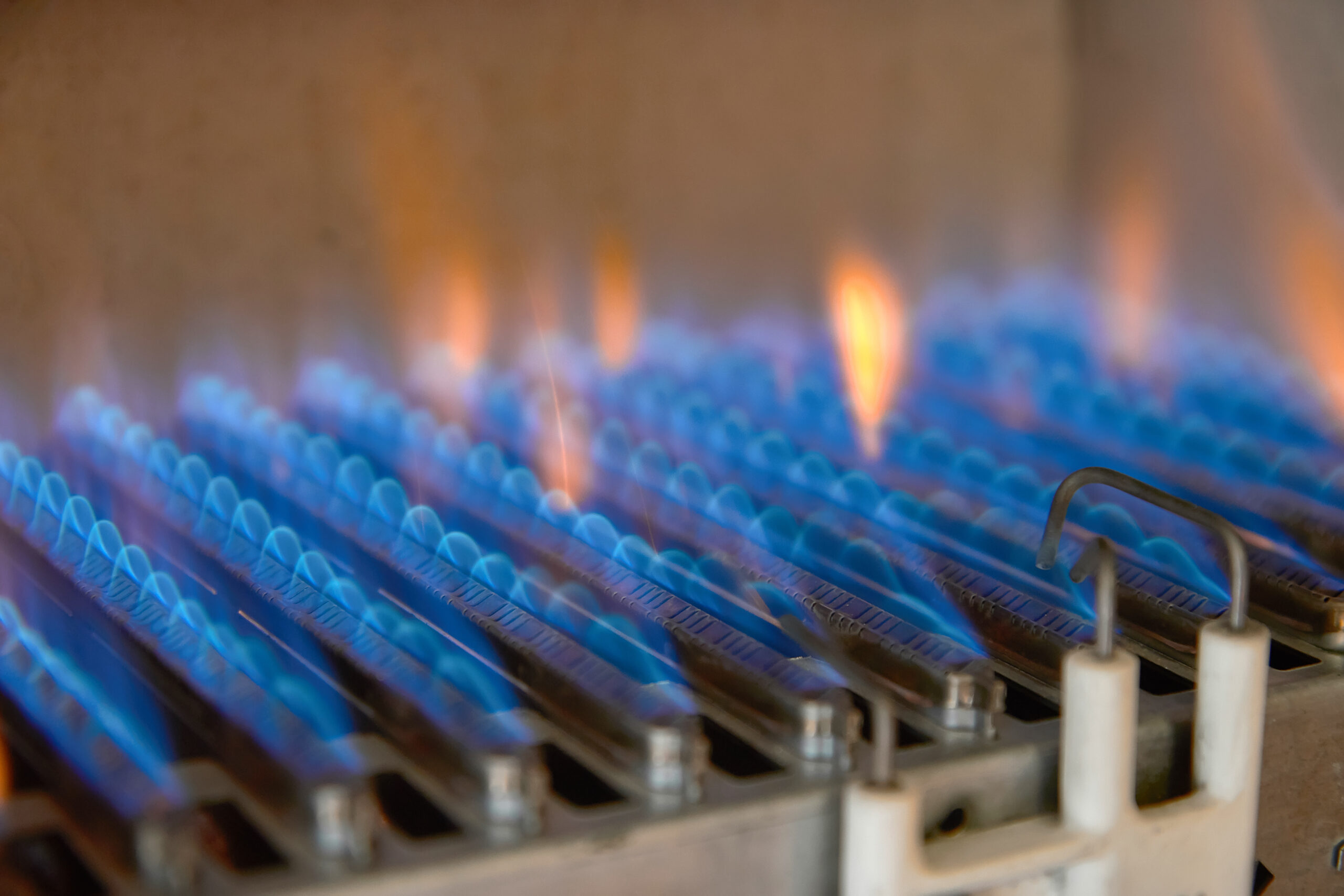 Gas burning in a heating appliance. A stainless steel burner heats a copper heat exchanger