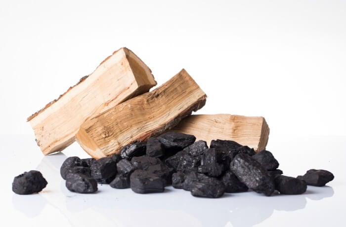 wood logs and coal in a pile