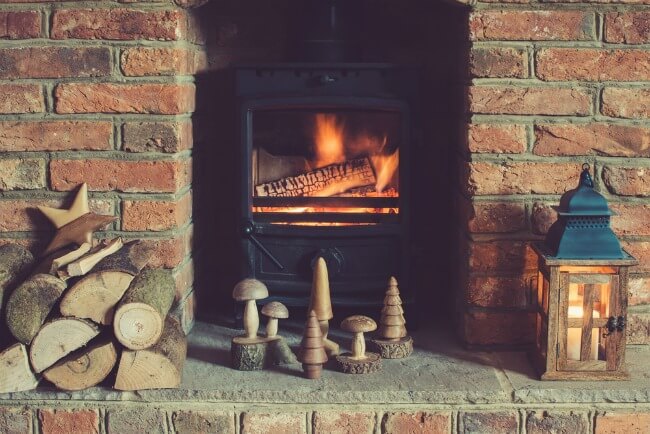 Shabby chic log burner with exposed brick fireplace